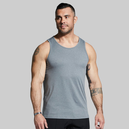 Man wearing a gray tank top against a plain background